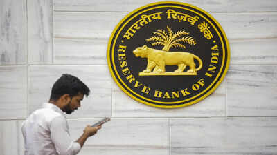 mumbai a man walks past the rbi logo at rbi headquarters in mumbai pti photo