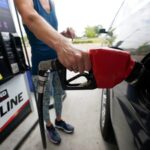 a customer readies to pump gas ap photo