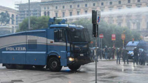 a police vehicle sprays a jet of water during a protest over the state of public services and the rising cost of living in milan