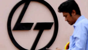 file photo an employee checks his phone next to a logo of lampt outside the larsen amp toubro precision manufacturing and systems complex on the outskirts of coimbatore
